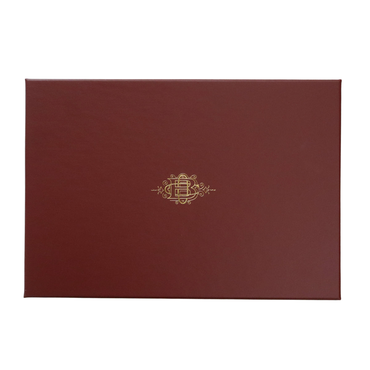 A rectangular dark red burgundy presentation box with a small gold decorative crest in the center, shown on a plain white background.