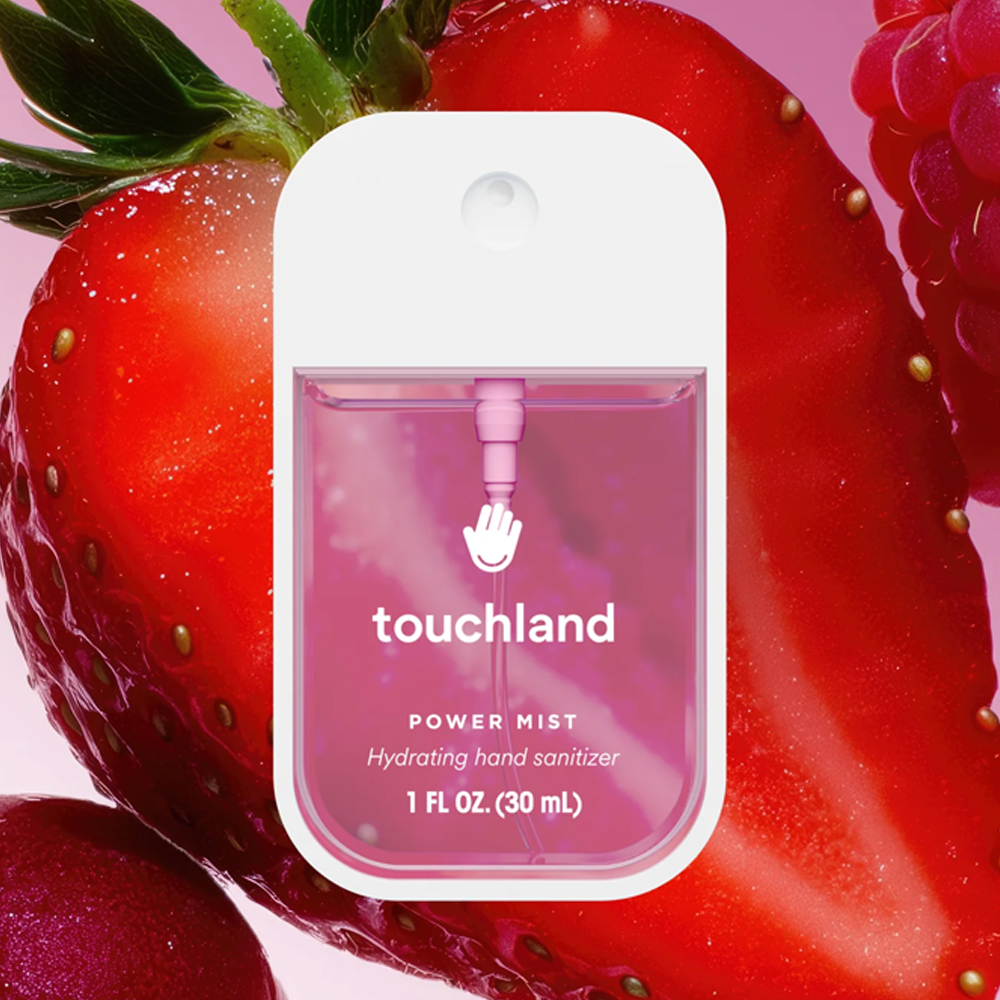 Touchland hand sanitizer packaging with strawberries in the background