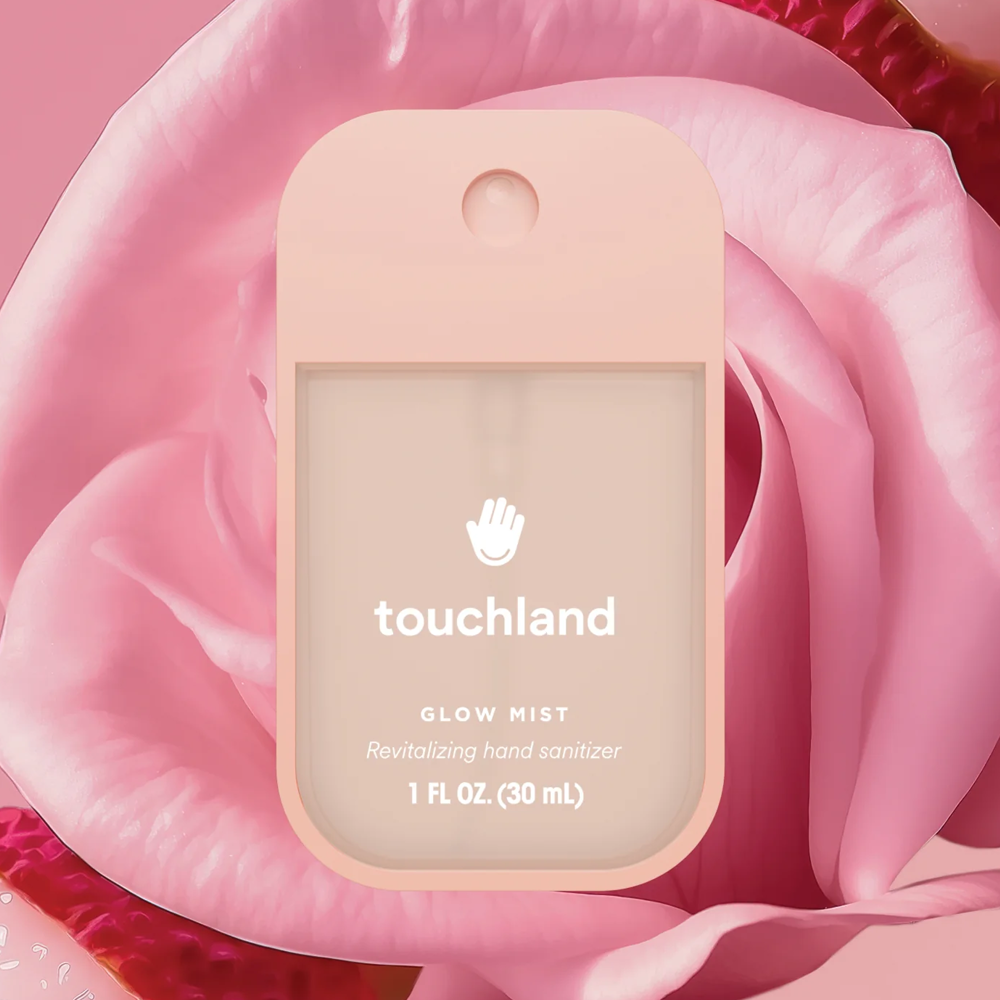 Touchland hand sanitizer on a pink rose with a pink background