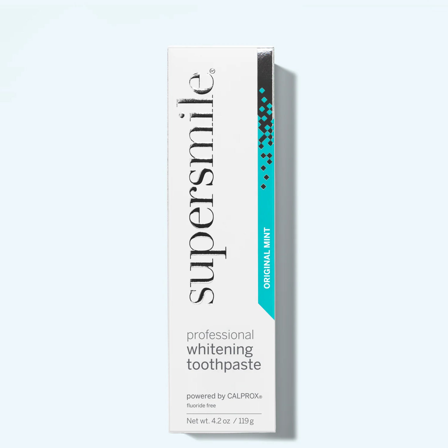 Supersmile professional whitening toothpaste box on a light gray background