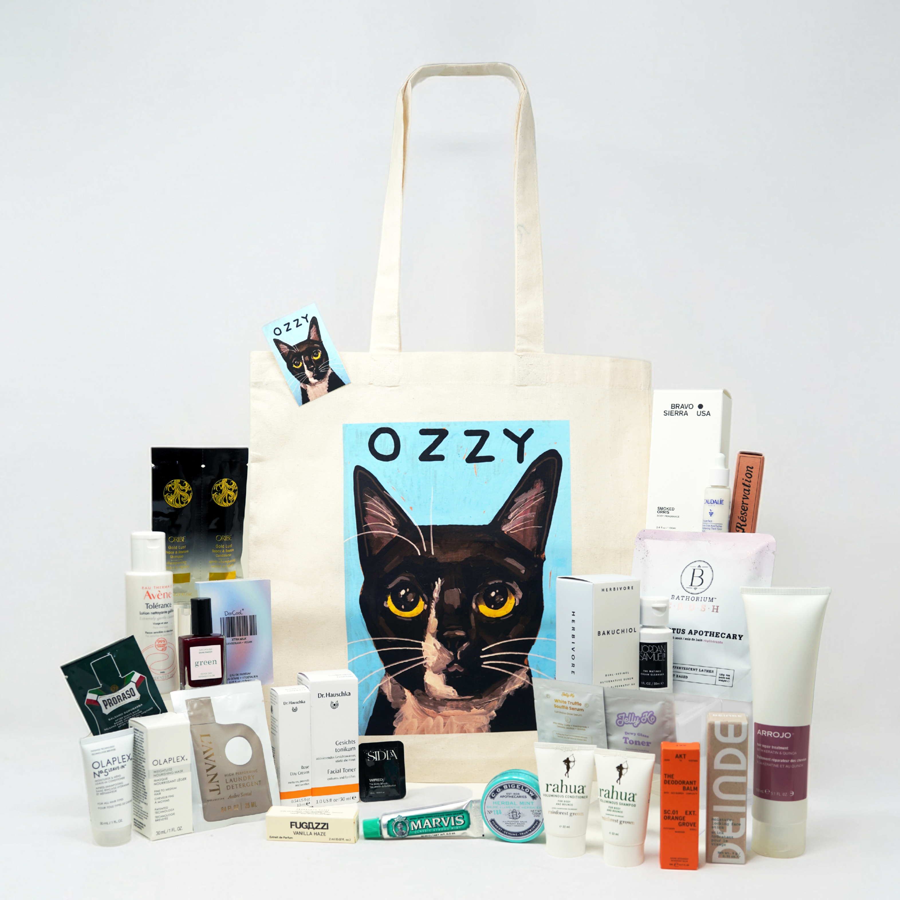 Tote bag with a cat illustration and various products on a white background