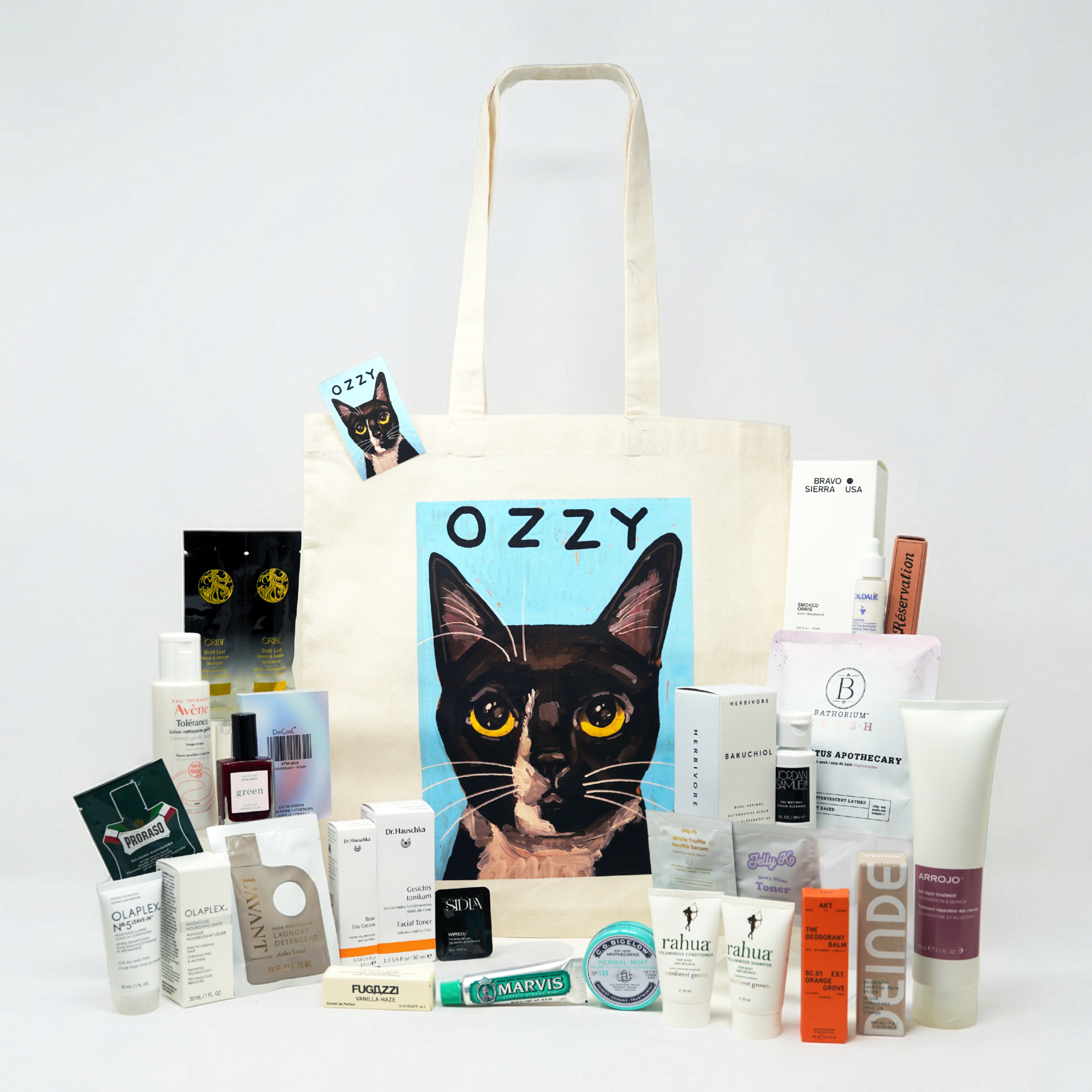 Tote bag with a cat illustration and various products on a white background