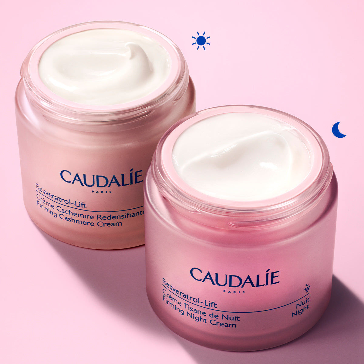 Two jars of Caudélé skincare cream on a pink background