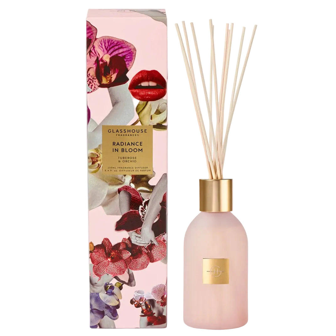 Pink diffuser bottle with floral design and matching packaging on a white background