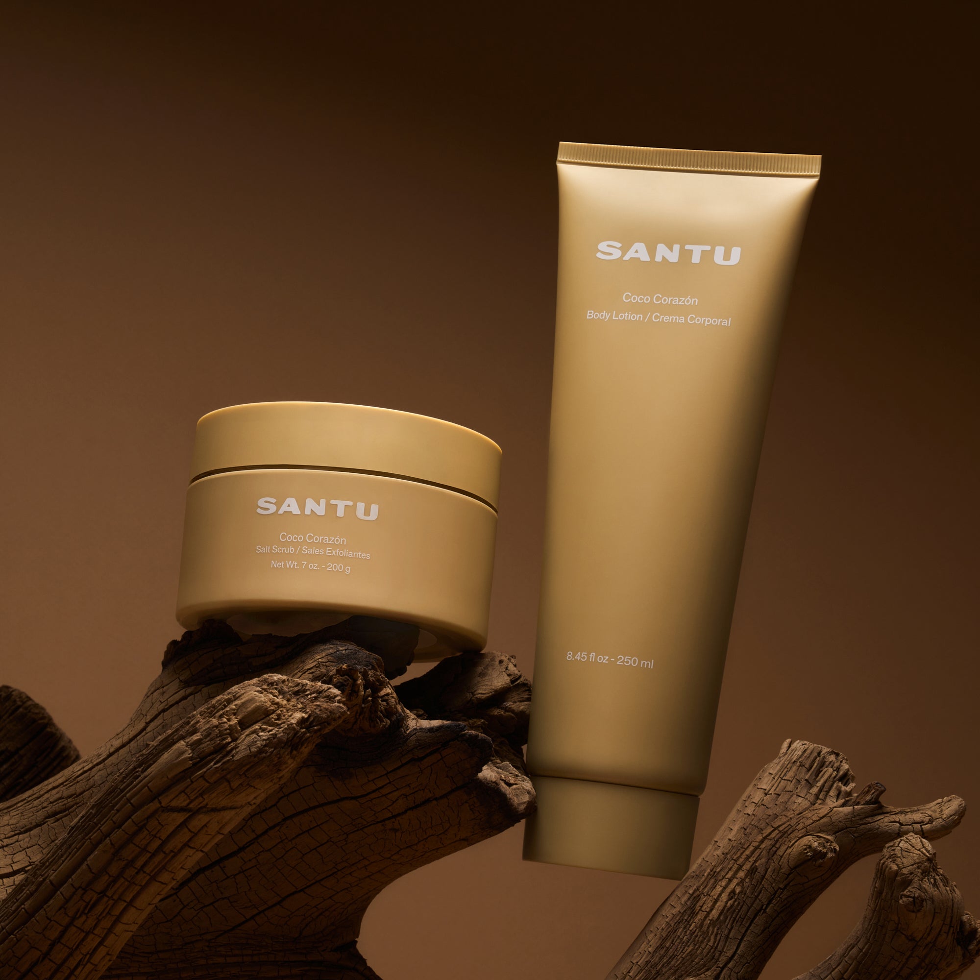 SANTU lotion and salt scrub on a wooden surface with a brown background