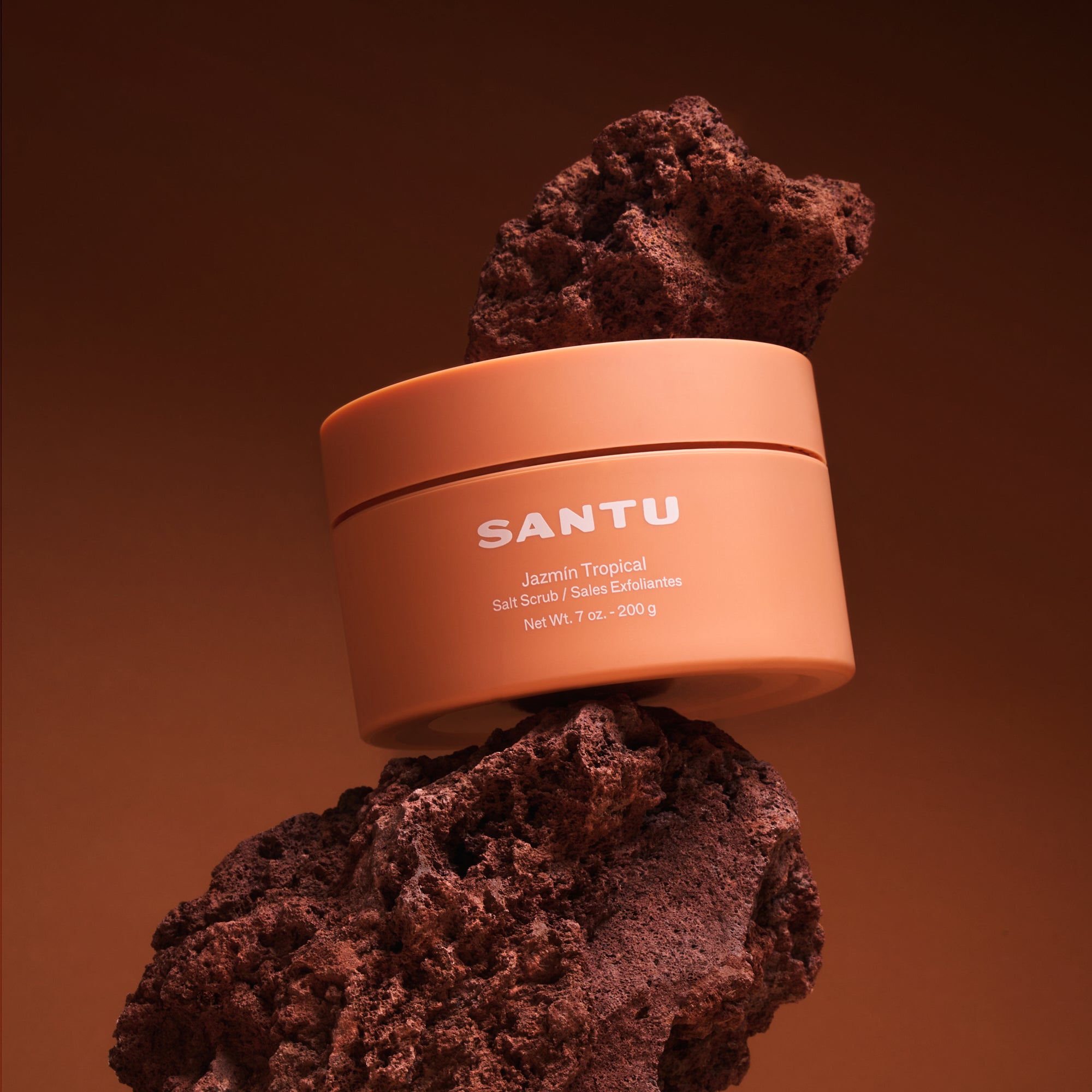 Orange jar labeled 'SANTU' on a brown textured background