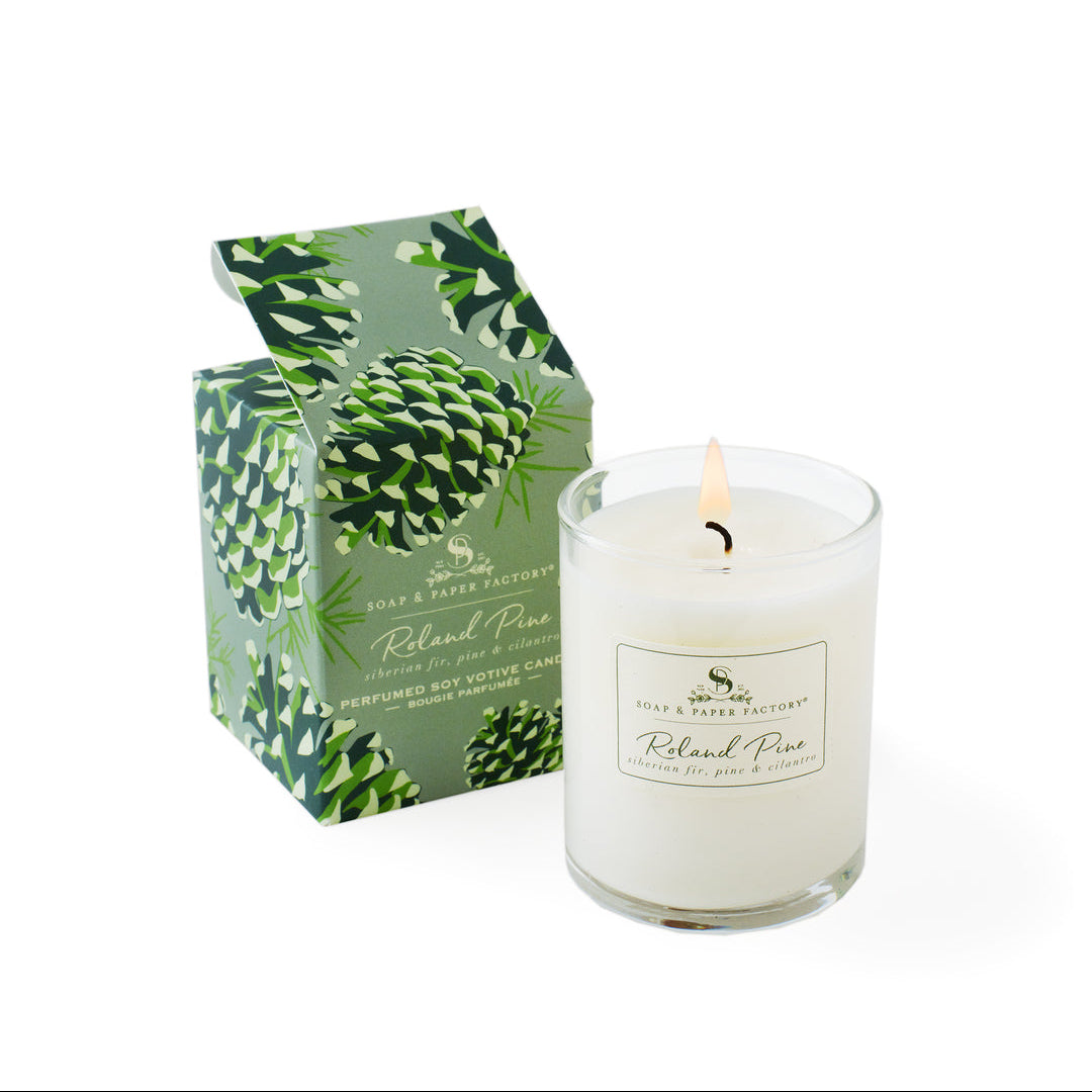 Roland Pine White candle with a green box featuring a pine cone design on a white background