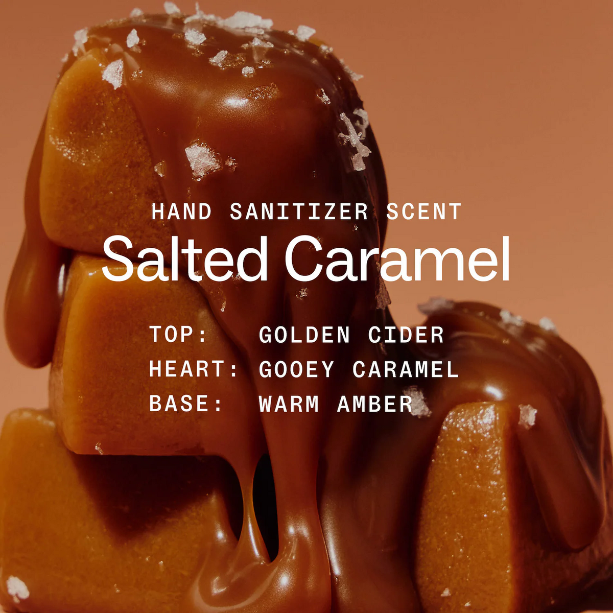 A close-up of a caramel-topped confection with white salt crystals on a warm brown background. White text reads 'HAND SANITIZER SCENT' and 'Salted Caramel,' with flavor notes 'TOP: GOLDEN CIDER,' 'HEART: GOOEEY CARAMEL,' and 'BASE: WARM AMBER.