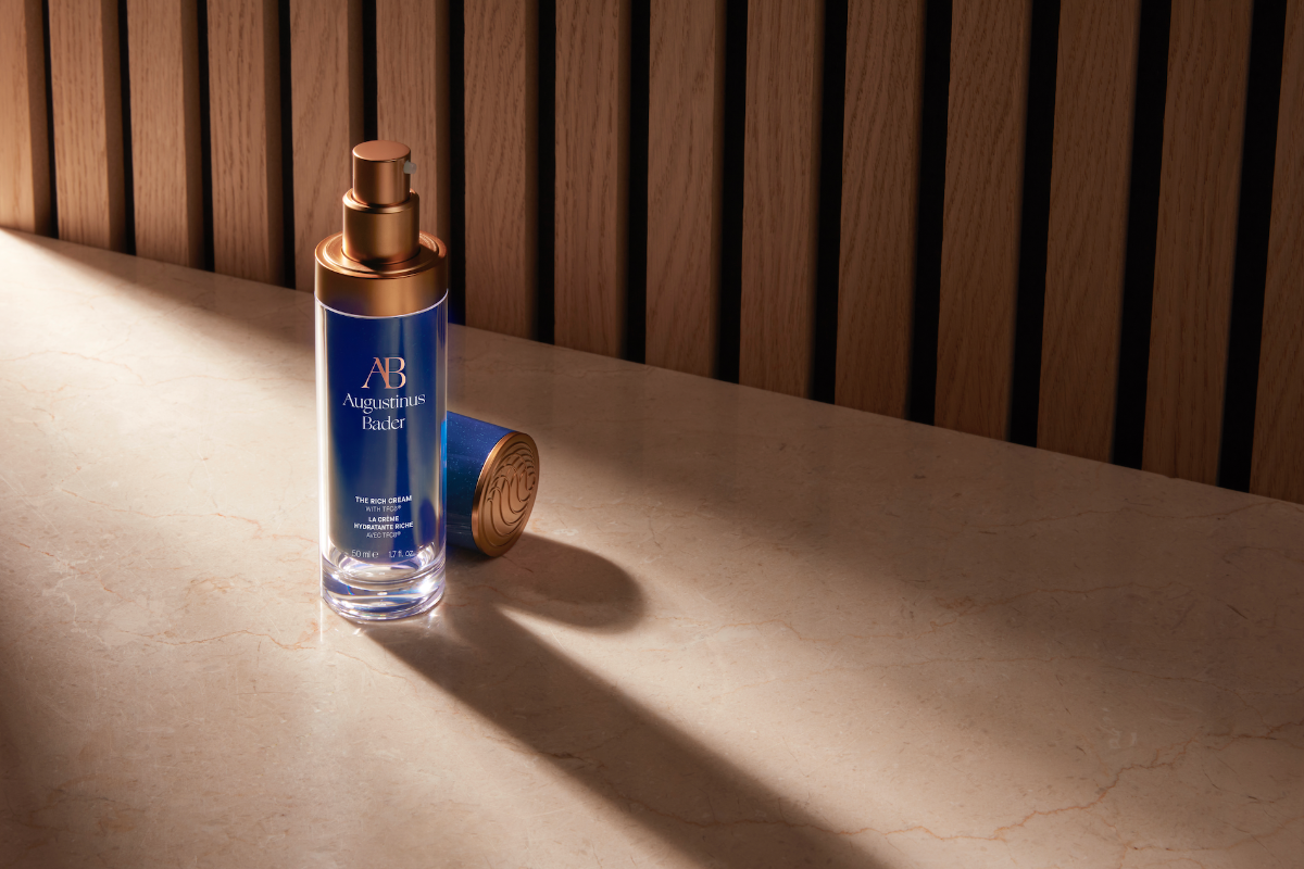 AB skincare bottle on a wooden surface with a slatted wood background