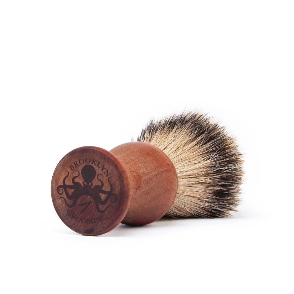 Shaving brush with wooden handle on a white background