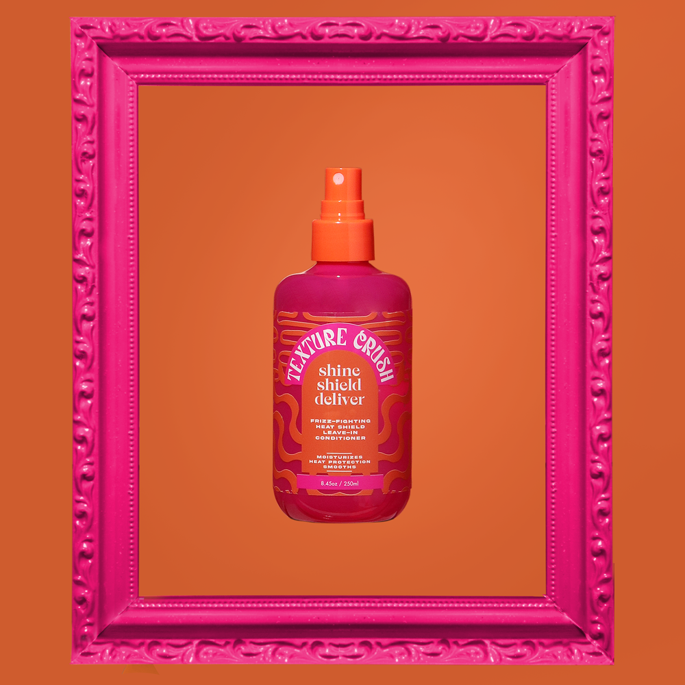 Pink bottle with orange nozzle on an orange background framed by a pink border