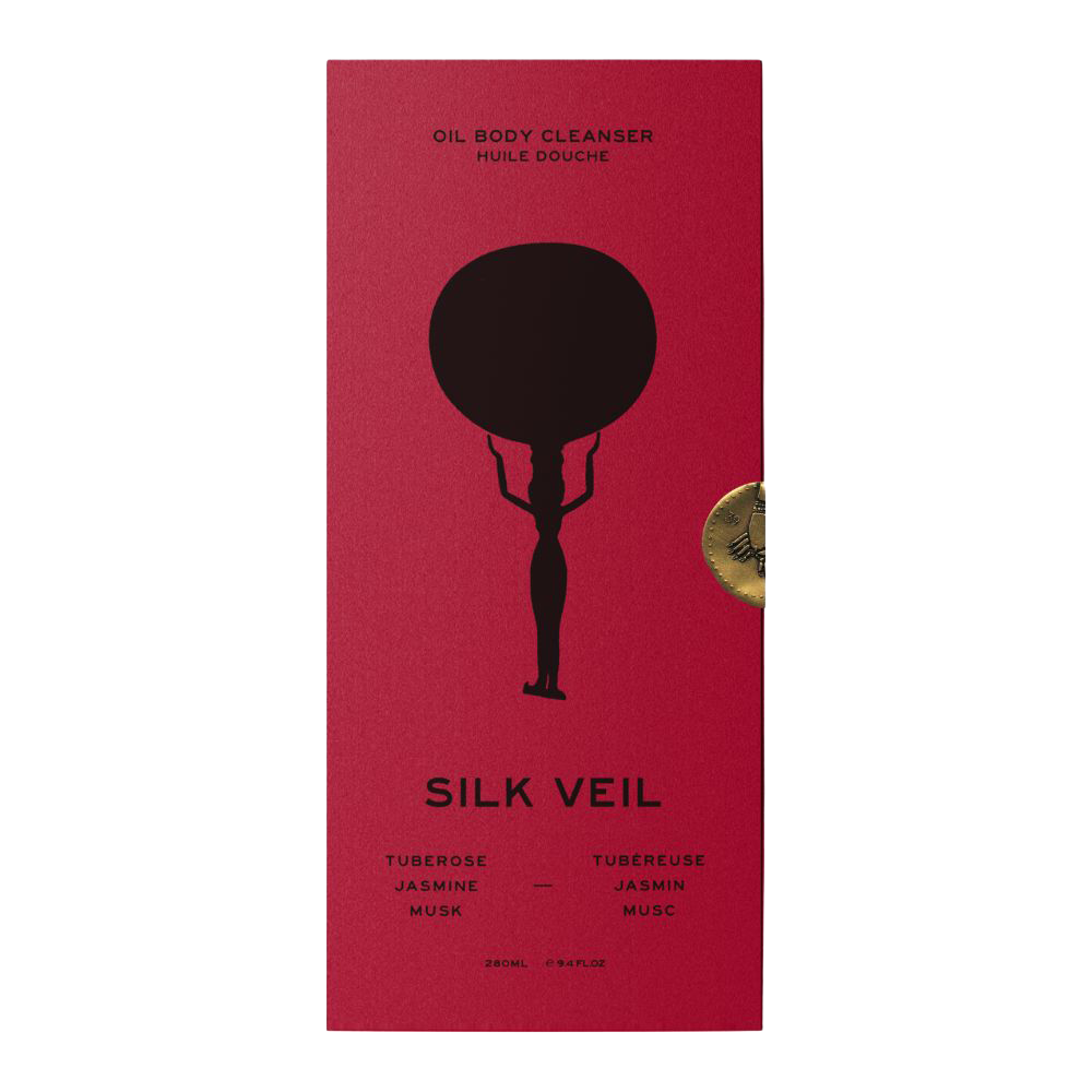 Red rectangular box for Silk Veil Oil Body Cleanser with a black silhouette graphic and a small round gold seal on the right side, shown on a plain white background.