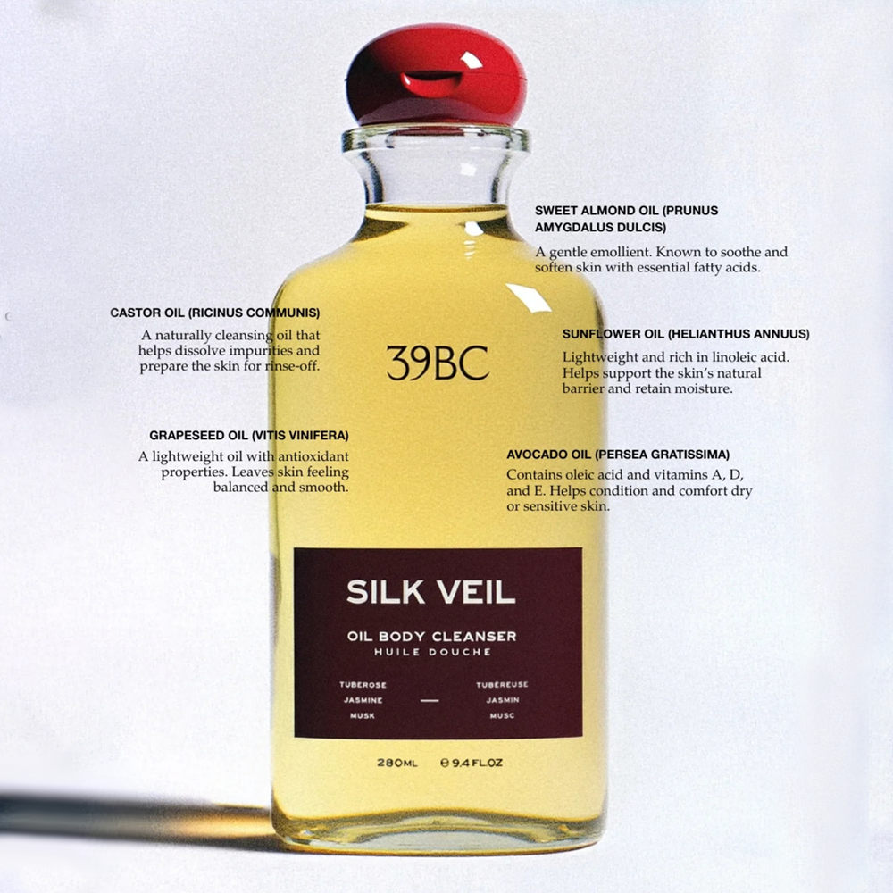 A 280ml glass bottle of 39BC Silk Veil Oil Body Cleanser, filled with yellow oil and topped with a red cap, shown against a white background with product ingredient descriptions overlaid.