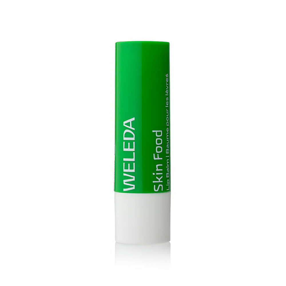 Weleda Skin Food lip balm with green cap and white body on a white background