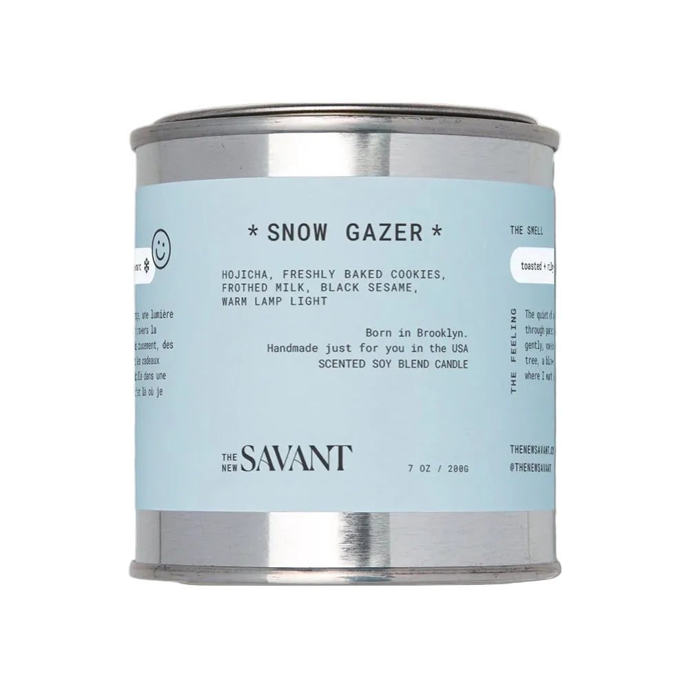 Candle container with 'Snow Gazer' label on a light background