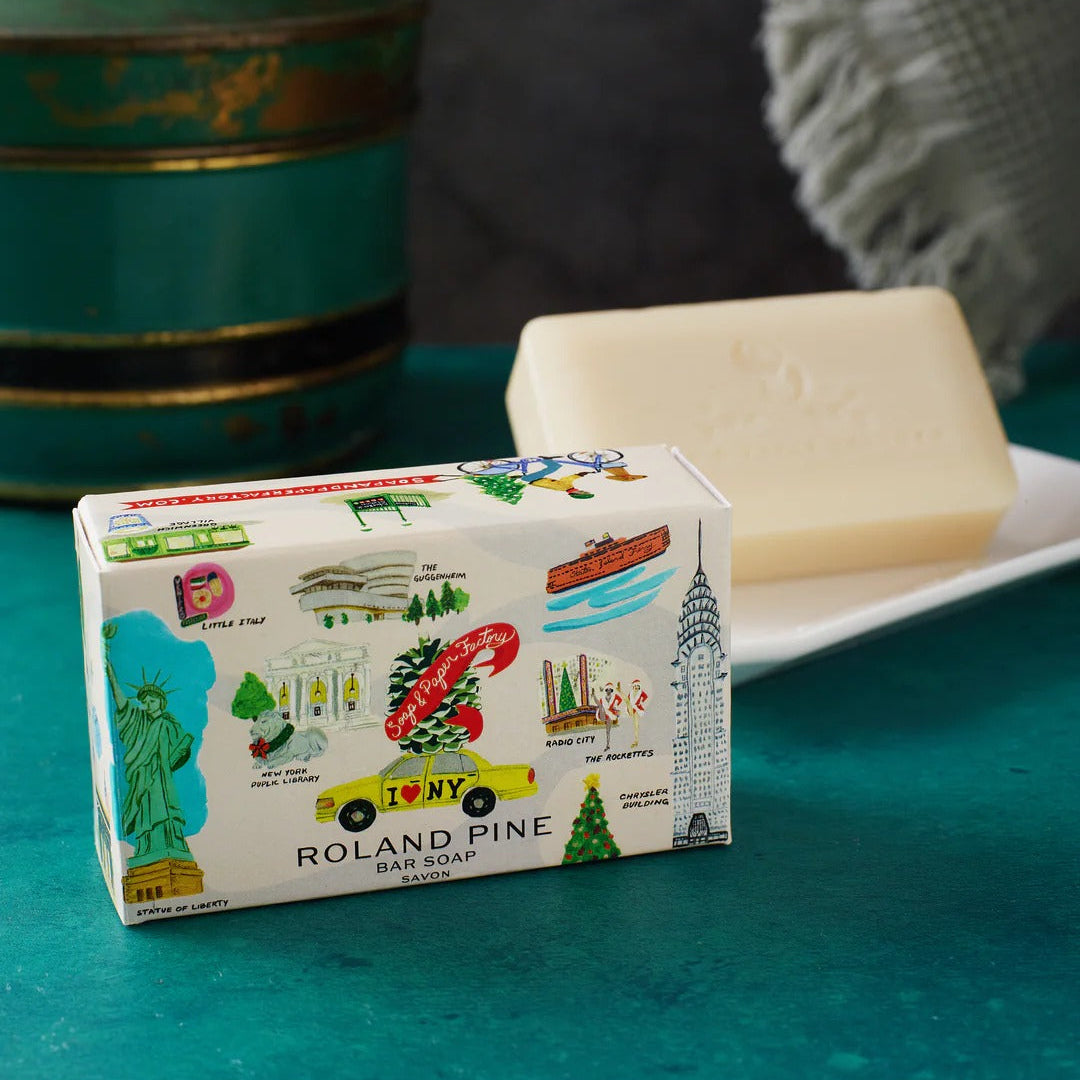 Roland Pine soap bar with decorative packaging on a teal surface