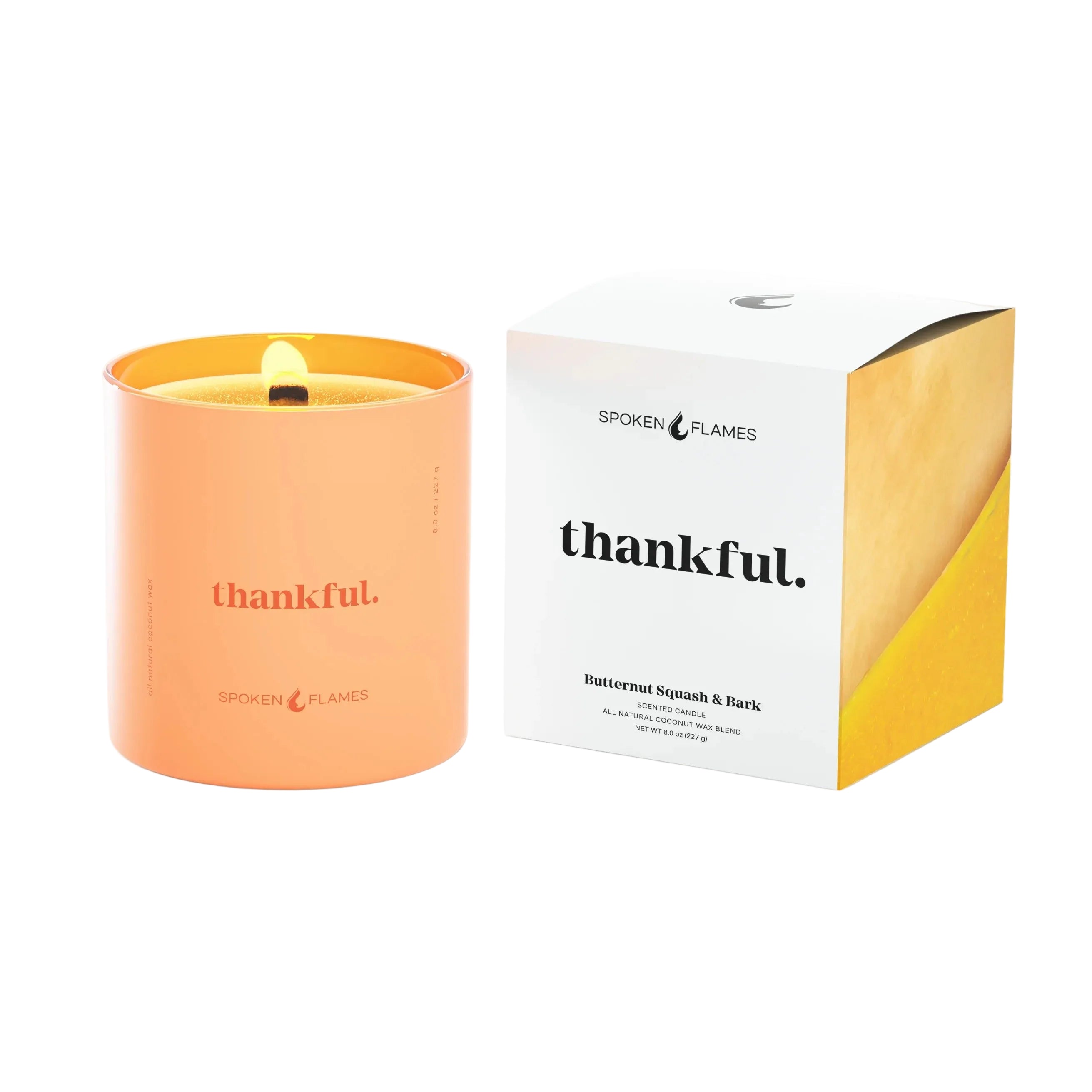 Orange candle with 'thankful.' text next to its packaging on a white background