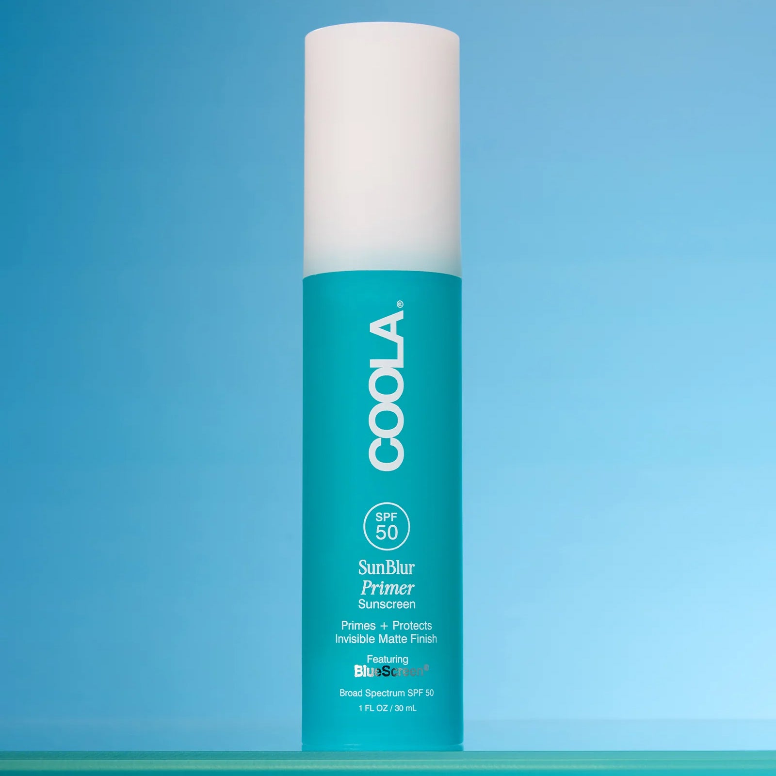 Coola SunBlur Primer product on a blue background