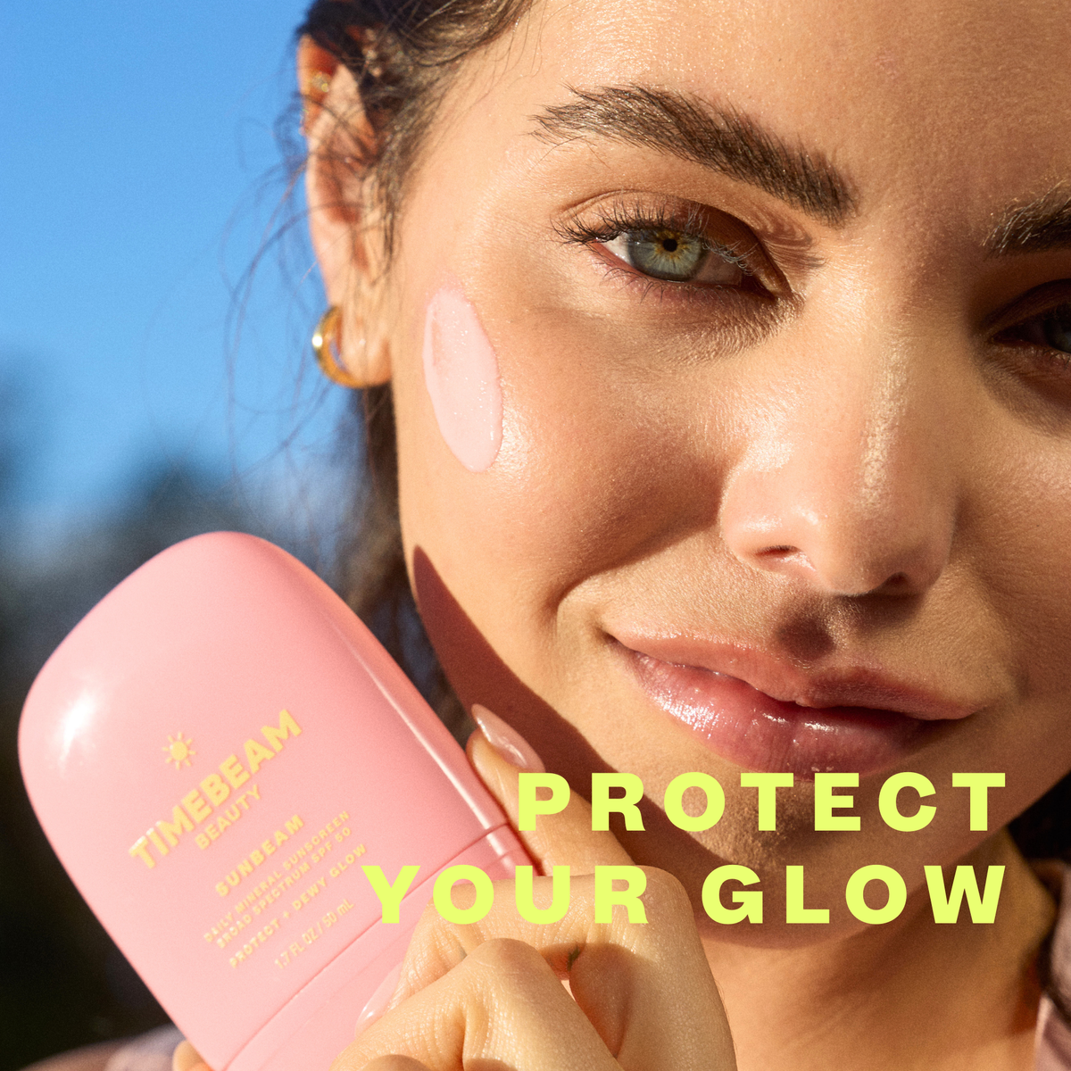Woman holding a pinkTimebeam product with 'Protect Your Glow' text overlay.