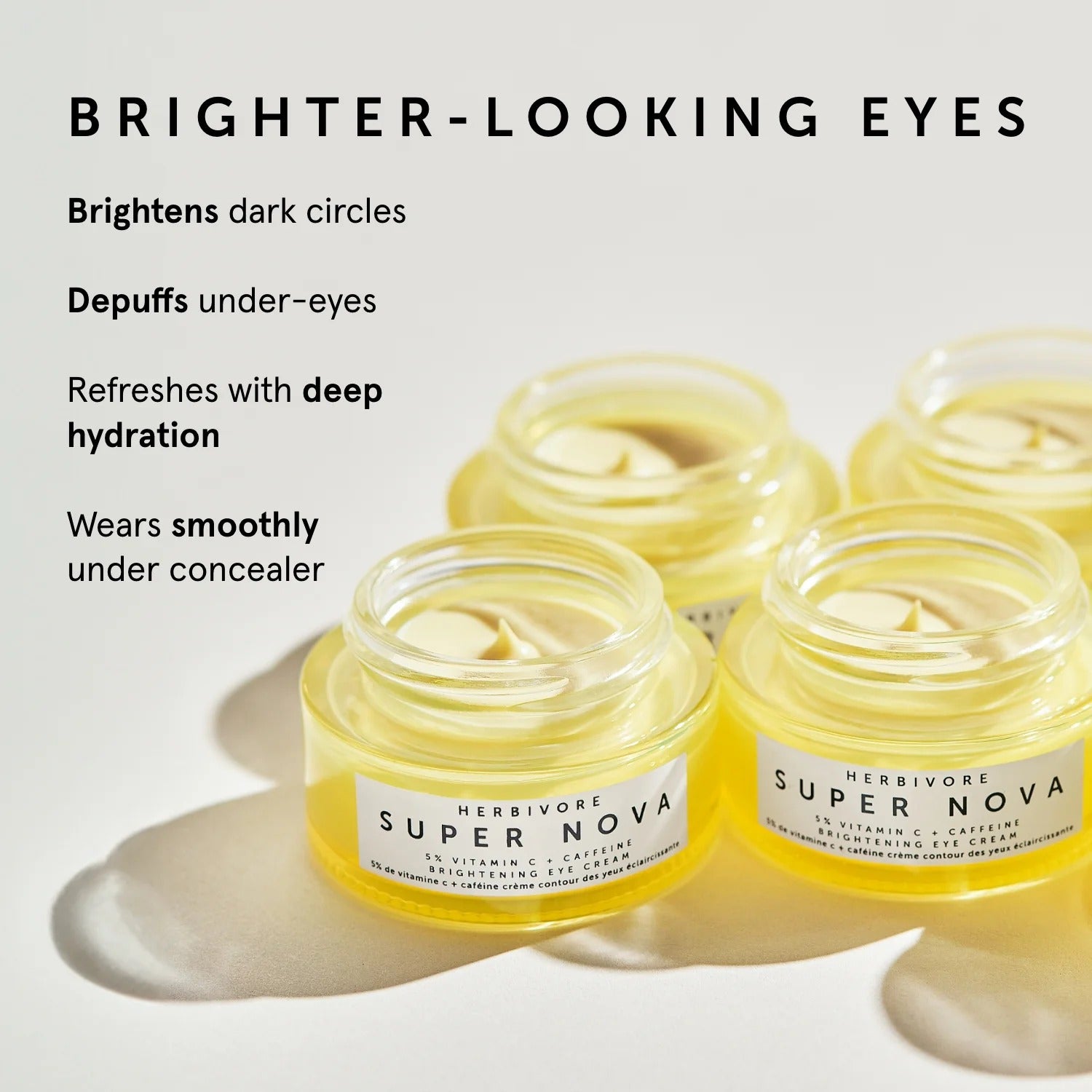 Herbivore Super Nova eye cream jars with text highlighting benefits on a light background