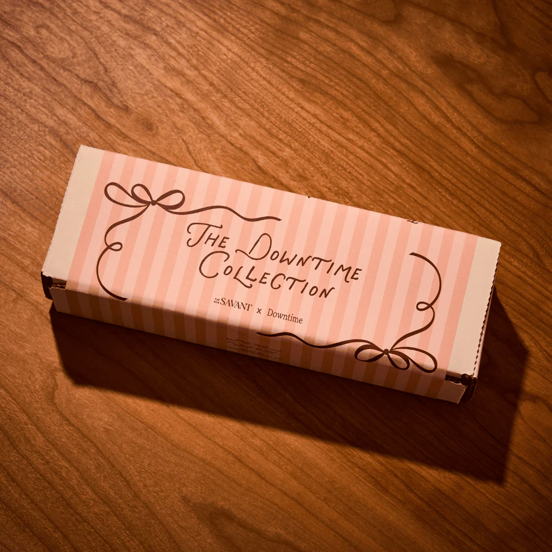 Product packaging with 'The Downtime Collection' text on a wooden surface