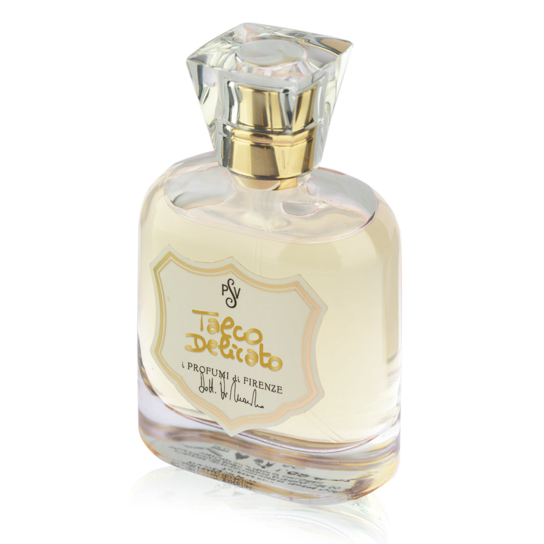 A bottle of Talco Delicato cologne by i Profumi di Firenze, featuring a clear glass bottle filled with pale yellow liquid, a gold spray nozzle, and a clear faceted cap, set against a plain white background.