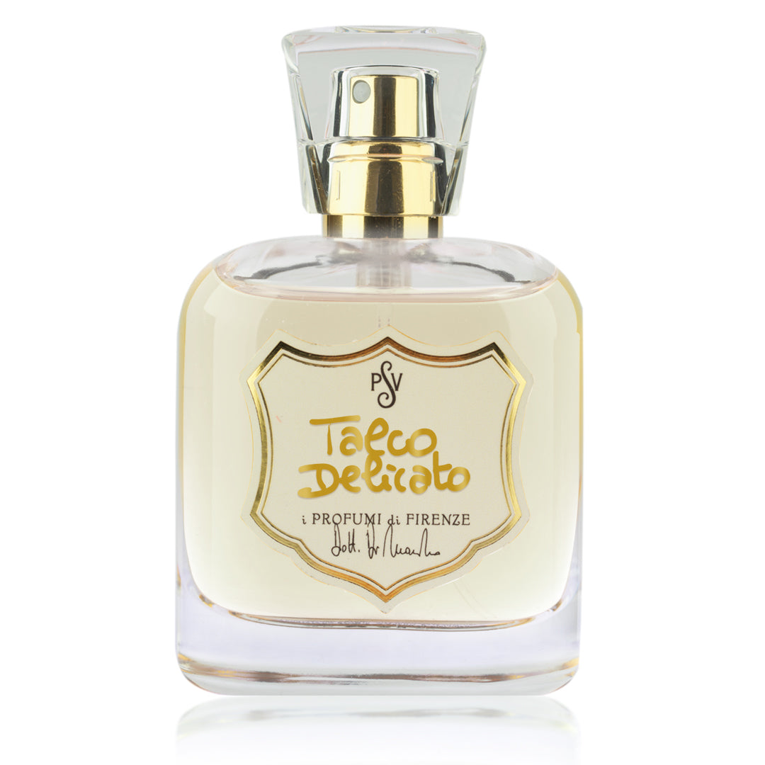 A bottle of Talco Delicato perfume by i Profumi di Firenze, featuring a clear glass bottle with a gold spray nozzle and a gold shield-shaped label on a white background.