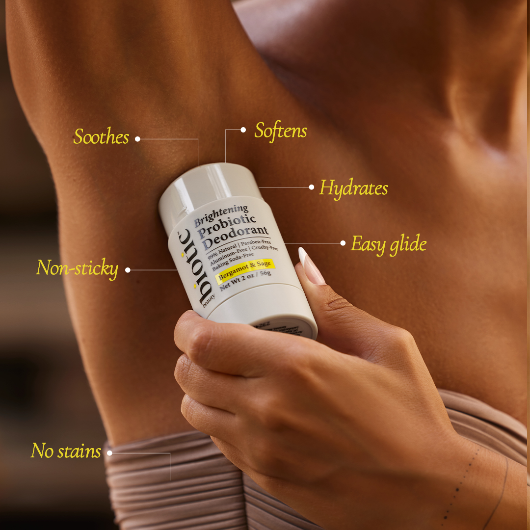 Someone applying Biotic Beauty's Brightening Probiotic Deodorant on their armpit with a list of the product benefits. (No Stains, Non-Sticky, Soothes, Softens, Hydrates, Easy Glide).