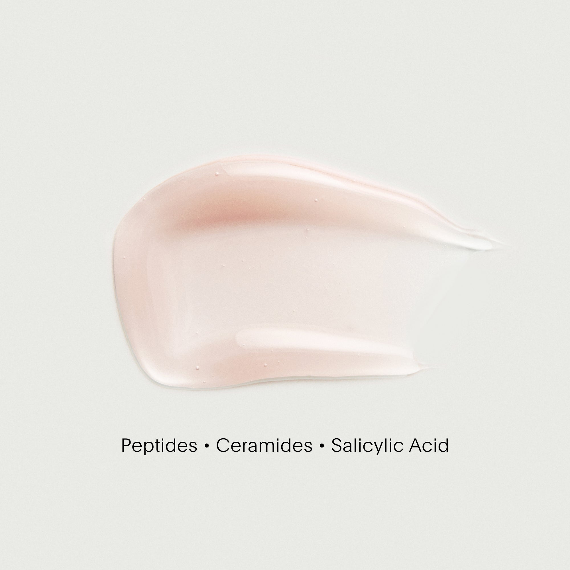 Pink cream swatch with text 'Peptides • Ceramides • Salicylic Acid' on a white background