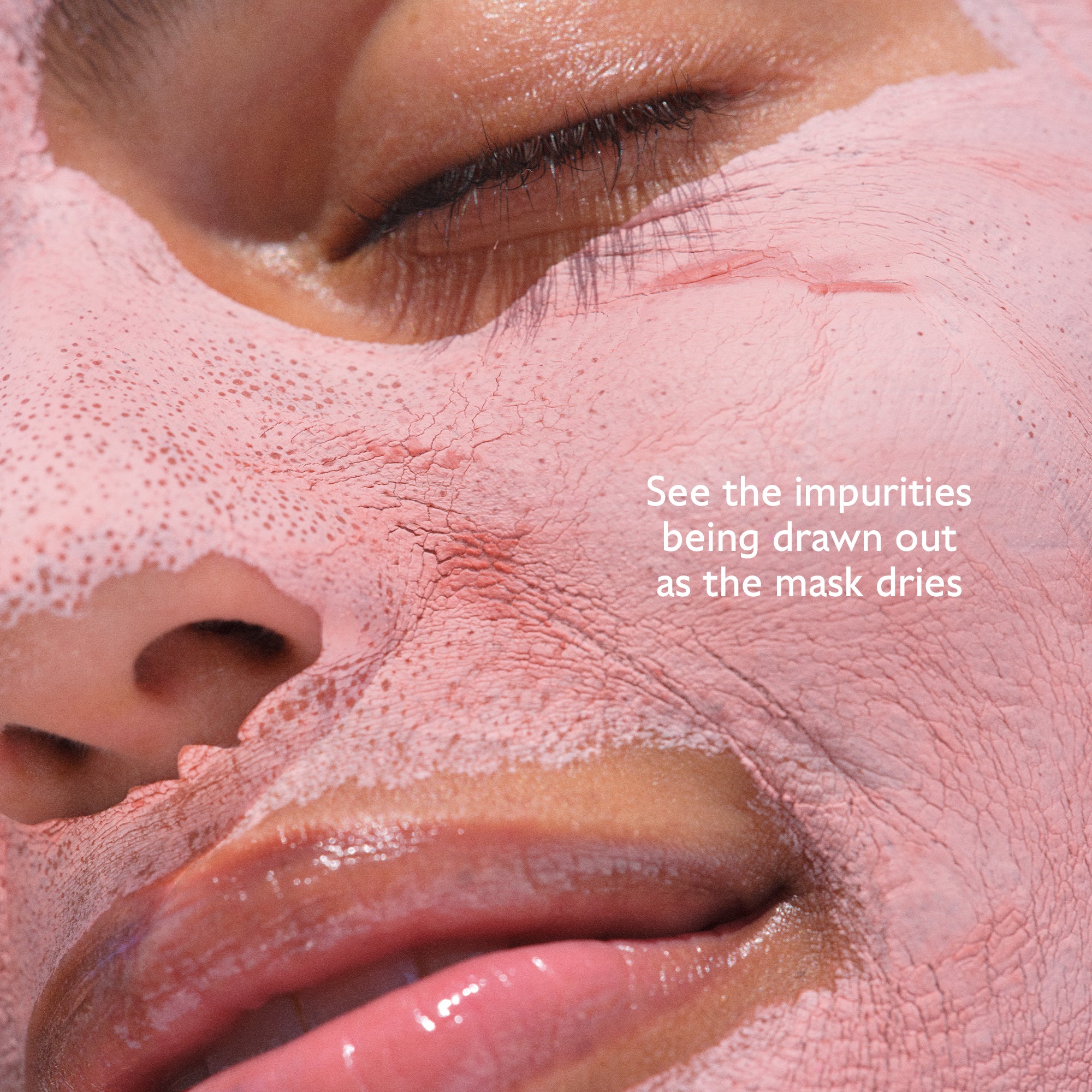 Close-up of a person's face with a pink facial mask applied, showing text about impurities being drawn out.