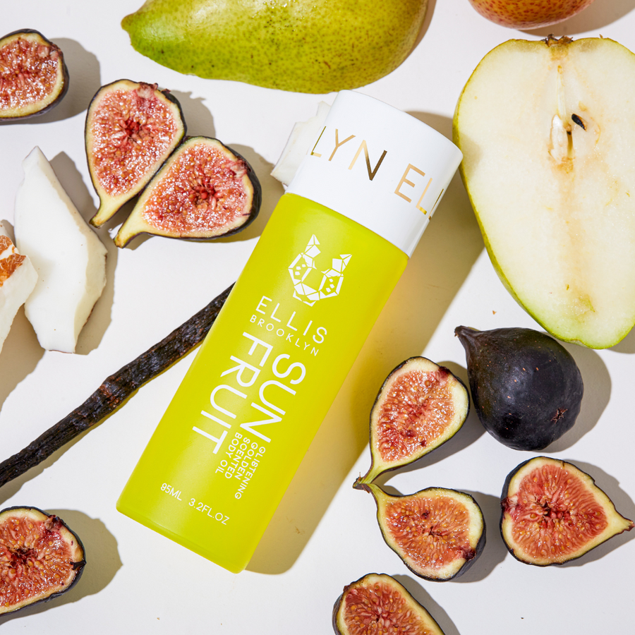 Sun fruit  bottle with figs and vanilla bean on a light background
