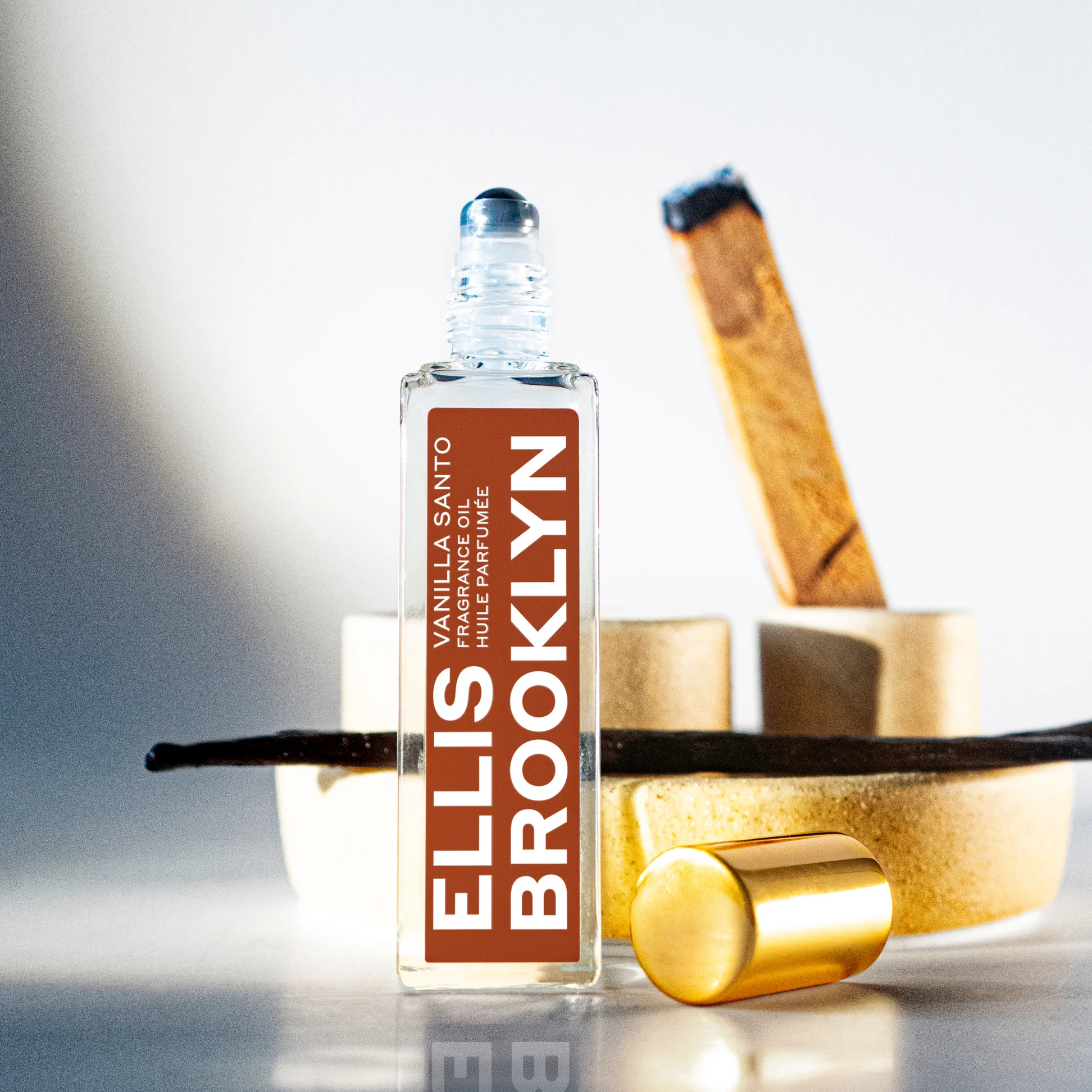 Ellis Brooklyn Vanilla Santo bottle with cap removed on neutral background with vanilla elements