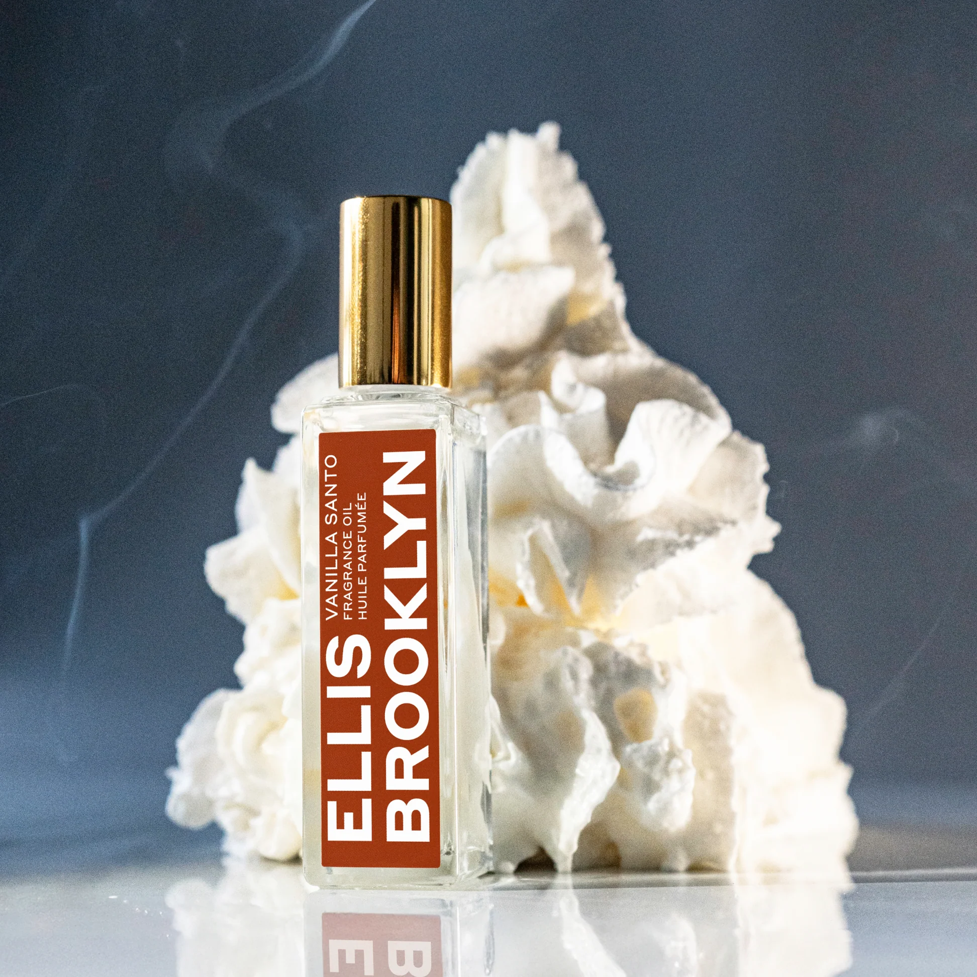 Ellis Brooklyn Vanilla Santo bottle with whipped cream on a darker neutral background