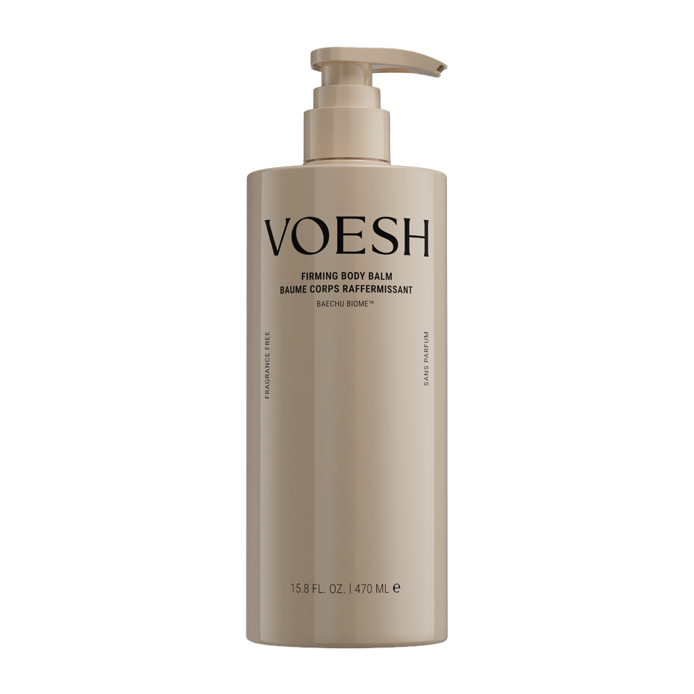 A tall, cylindrical pump bottle of VOESH Firming Body Balm in a warm beige color, shown against a solid white background.