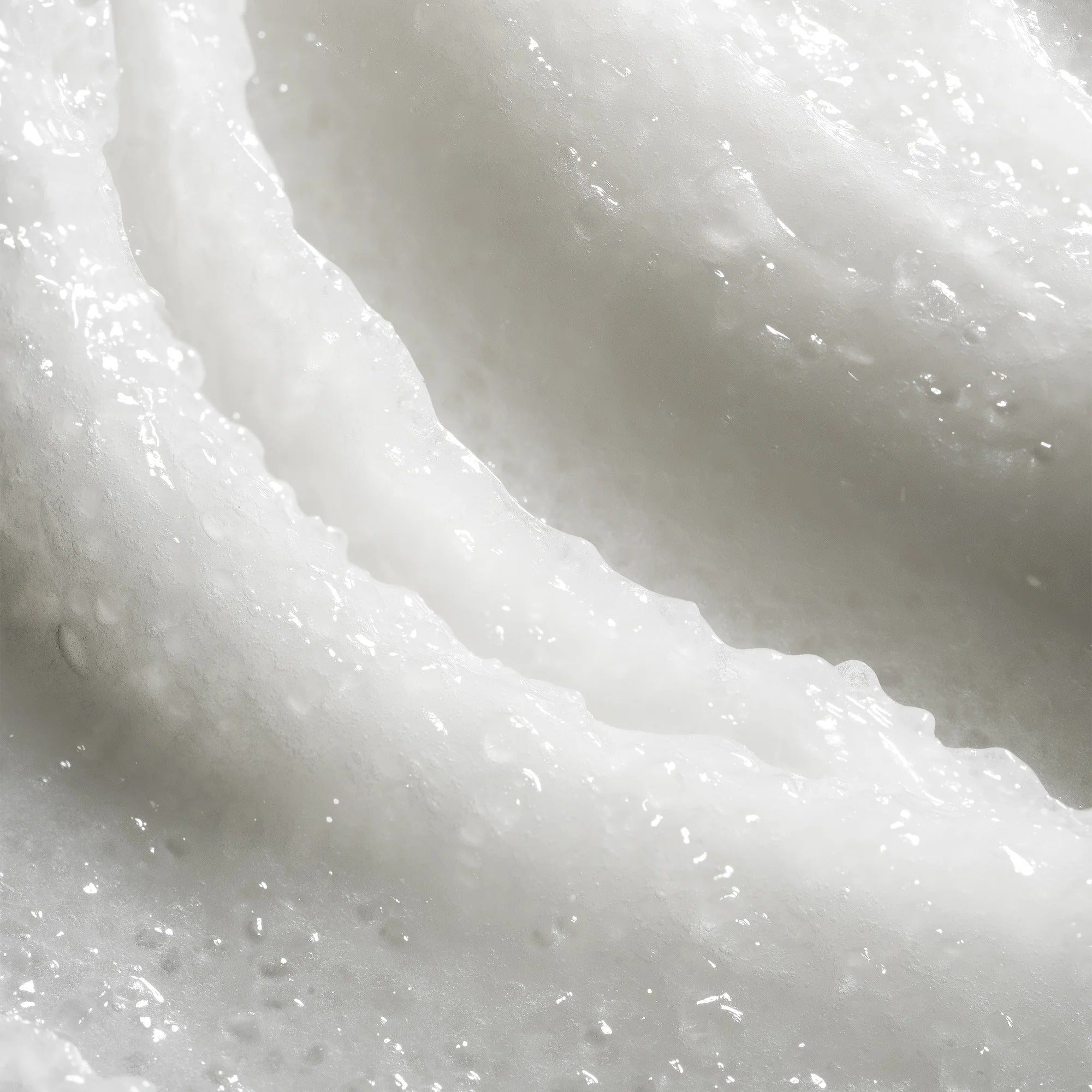 Close-up of white, creamy substance with a textured surface.