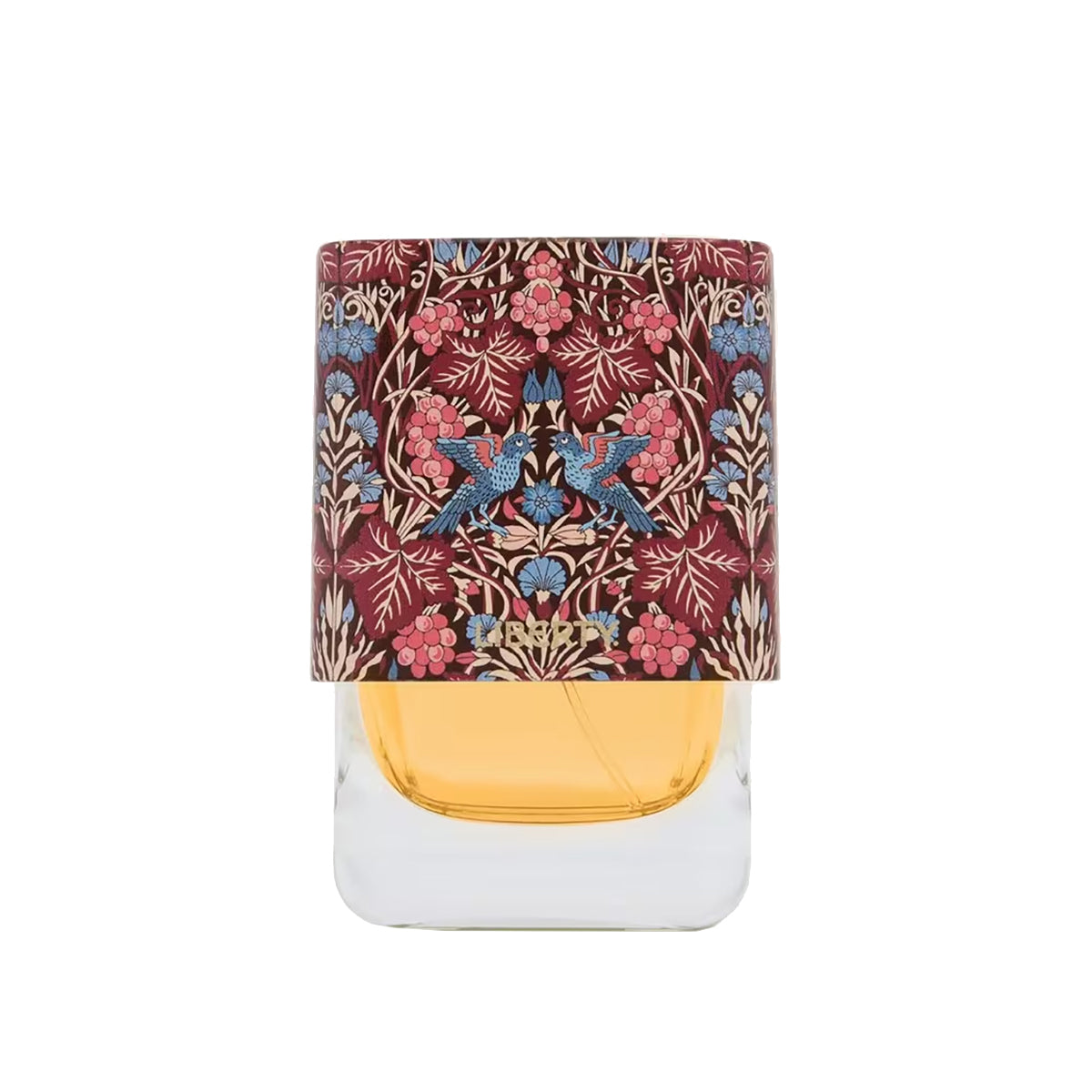 Perfume bottle with floral and bird design on the cap against a white background