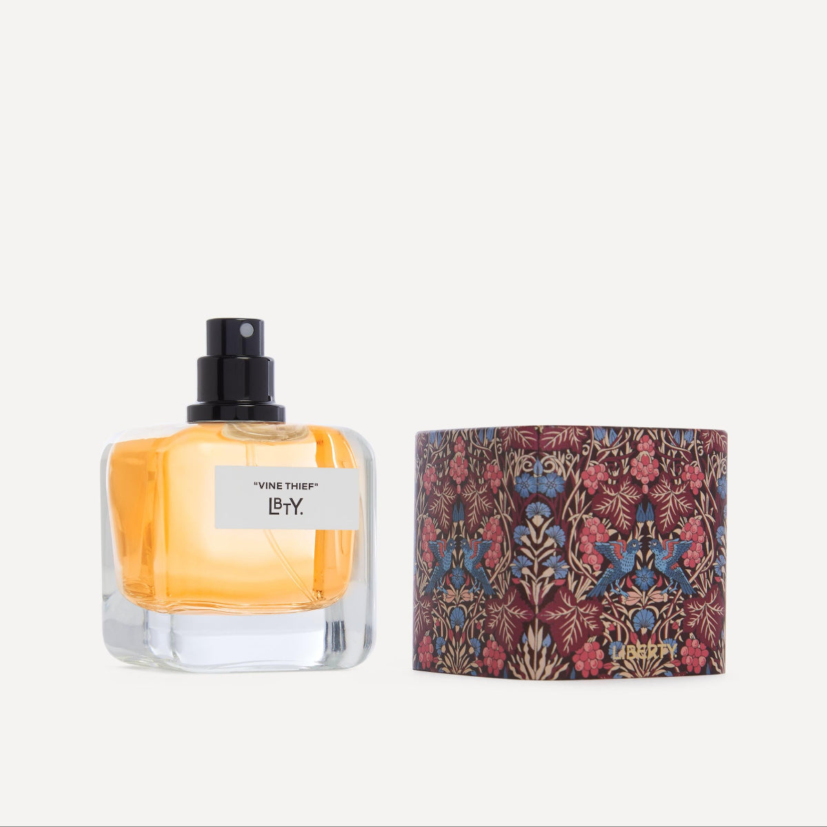 Perfume bottle with floral packaging on a white background