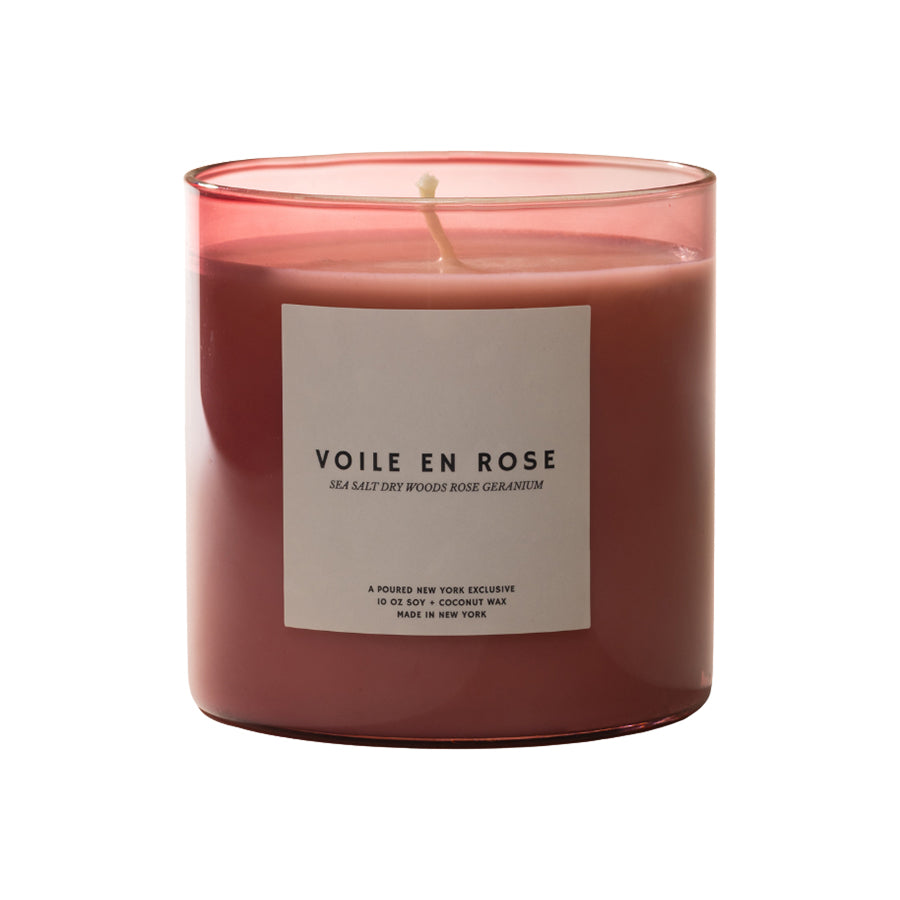 Pink candle with a label on a white background