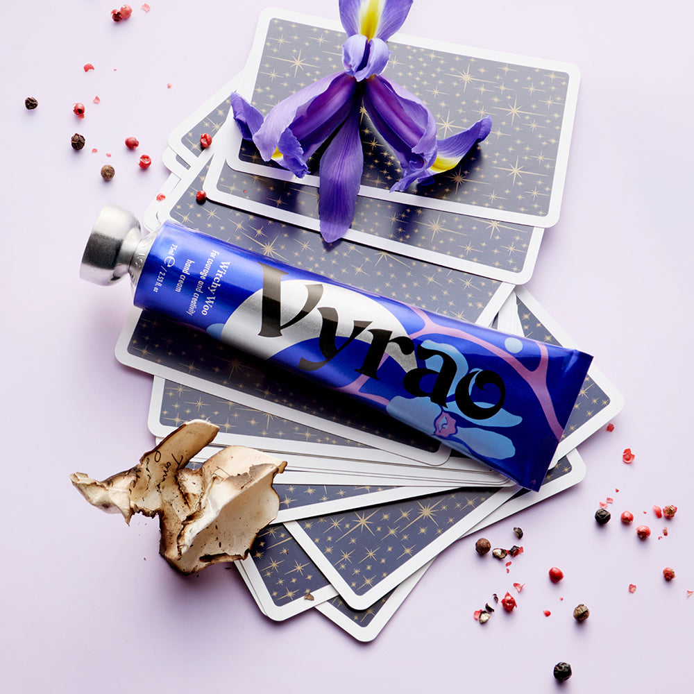 Pyrao product packaging with tarot cards and a purple flower on a light purple background