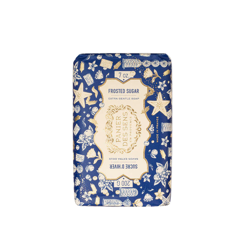 Soap bar with decorative packaging featuring starfish and floral patterns on a blue background.