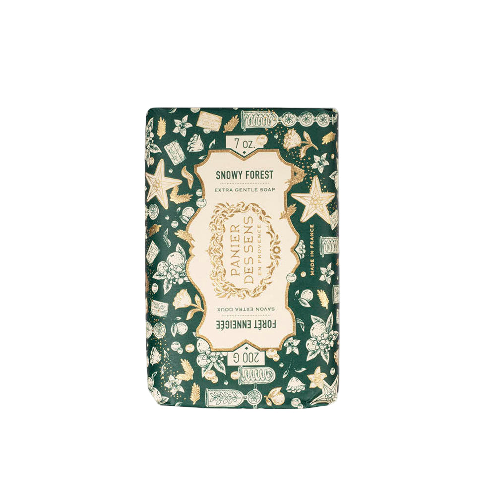 Bar of soap with decorative packaging featuring nature-themed illustrations on a white background