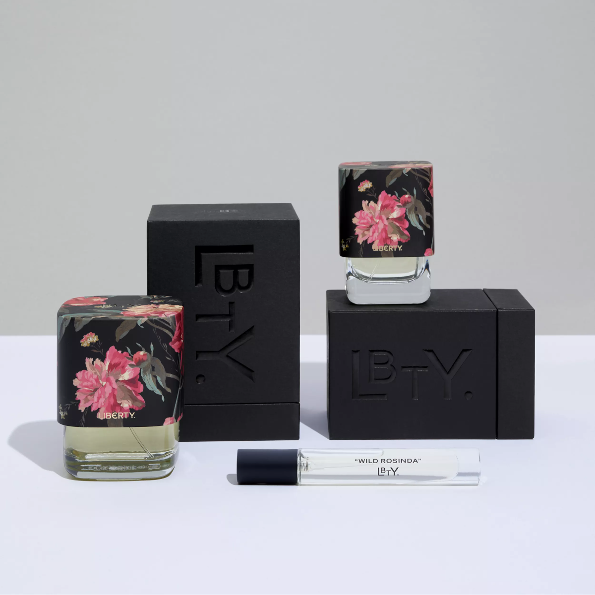Perfume bottles with floral design and 'LB.Y' branding on a gray background