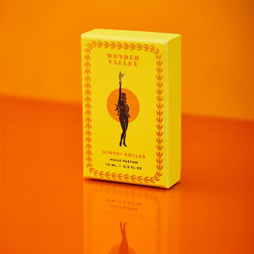 Yellow box of Wonder Valley perfume on an orange background