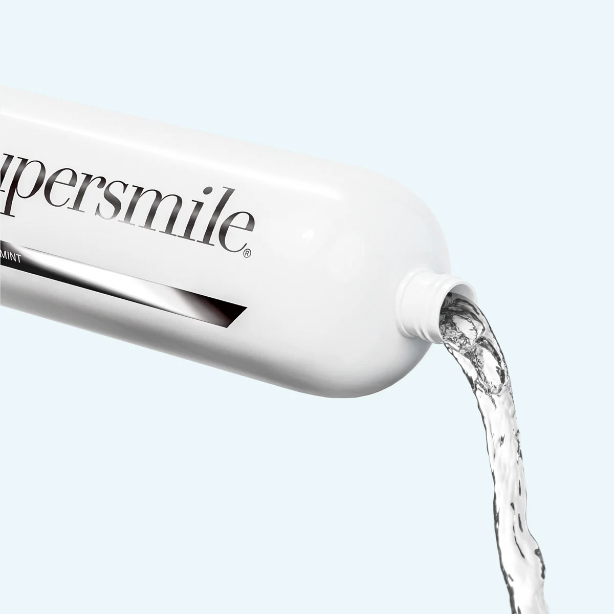 Supersmile whitening rinse bottle with liquid flowing out on a light blue background