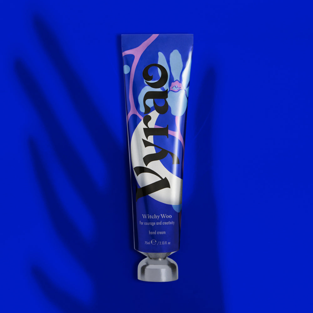Blue tube of Dior hand cream on a blue background