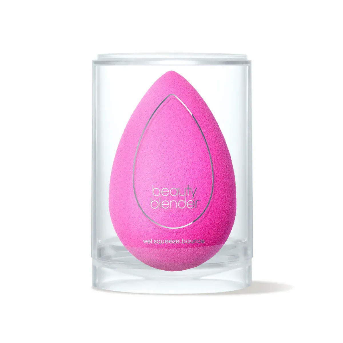Pink beauty blender in a clear container on a white background