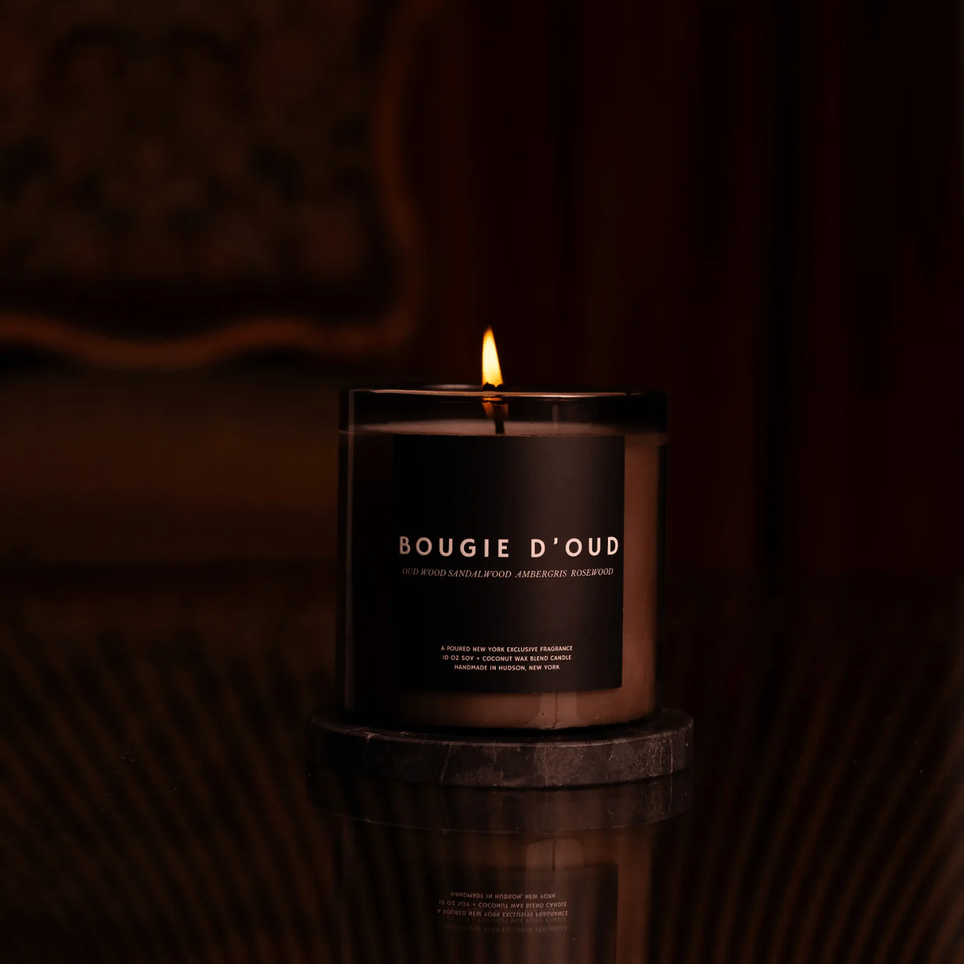 Bougie D'Oud candle with a dark background
