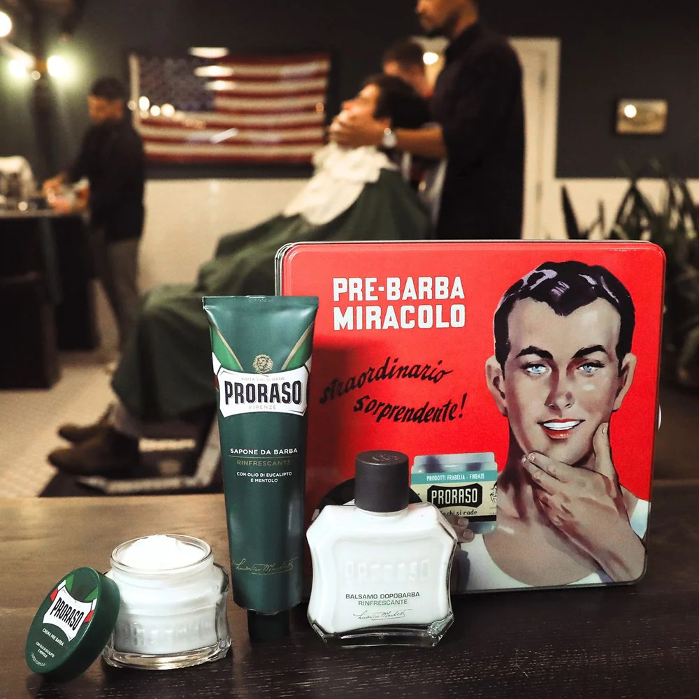 Barber shop setting with Proraso products and a vintage tin