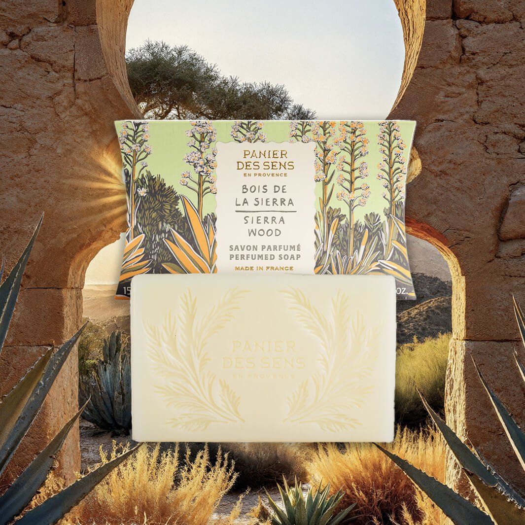 Sierra Wood Bar of soap with packaging featuring nature-themed design against a desert landscape background