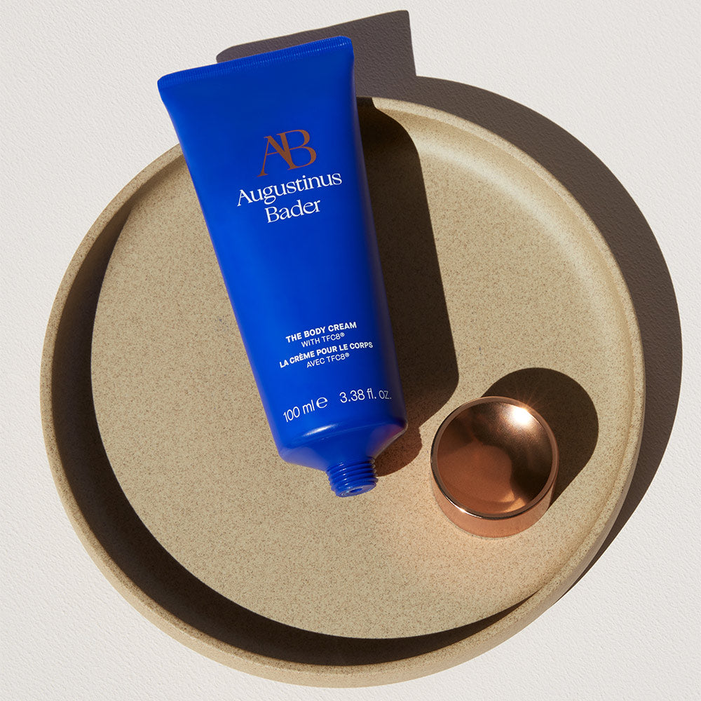 Augustinus Bader Body Cream on a ceramic plate
